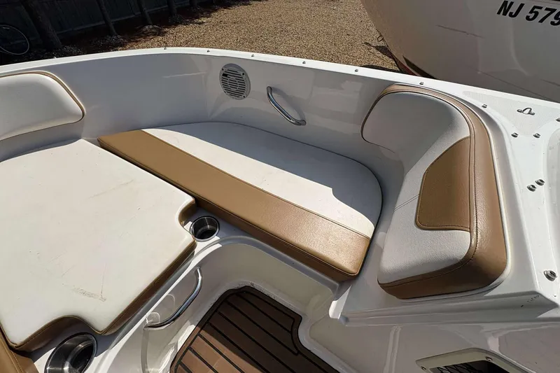 Slide: The Image of 2020 Bayliner VR4 Bowrider OB interior with tan and white seating, cup holders, and speaker. - 15