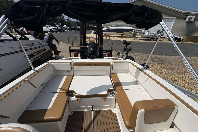 Slide: The Image of 2020 Bayliner VR4 Bowrider OB with tan and white seating, docked outdoors. - 16