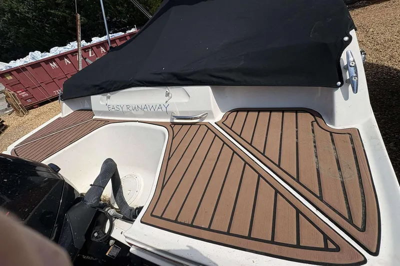 Slide: The Image of 2020 Bayliner VR4 Bowrider OB with covered deck and wood-patterned flooring. - 18