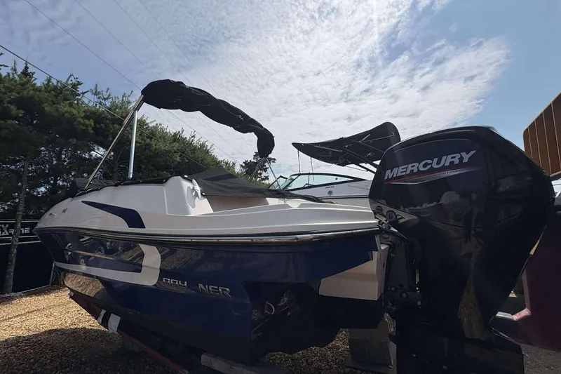 Slide: The Image of 2020 Bayliner VR4 Bowrider OB with Mercury outboard motor under a cloudy sky. - 2