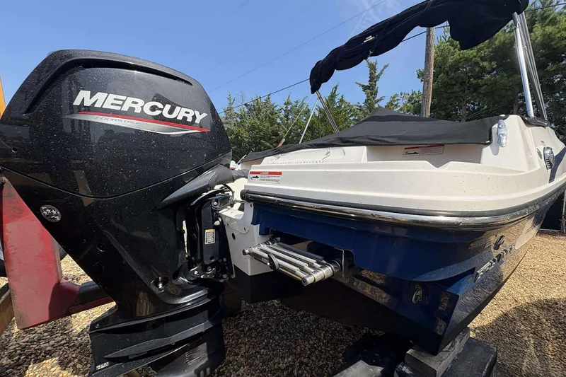 Slide: The Image of 2020 Bayliner VR4 Bowrider OB with Mercury outboard engine, parked on gravel. - 4