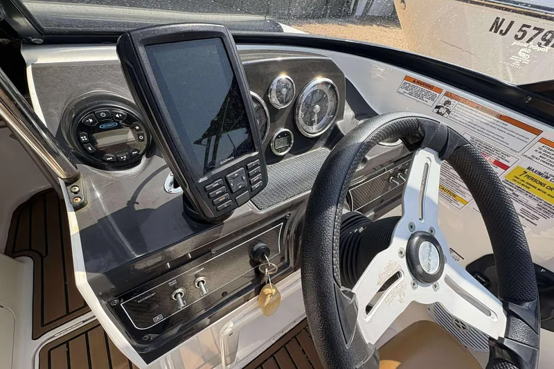 Slide: The Image of 2020 Bayliner VR4 Bowrider OB dashboard with steering wheel and navigation system. - 6