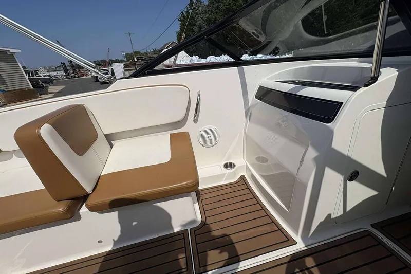 Slide: The Image of 2020 Bayliner VR4 Bowrider OB interior with tan and white seating, wood-style flooring. - 9