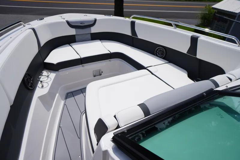Slide: The Image of 2025 Chaparral 280 OSX boat interior with sleek white seating and modern design. - 19