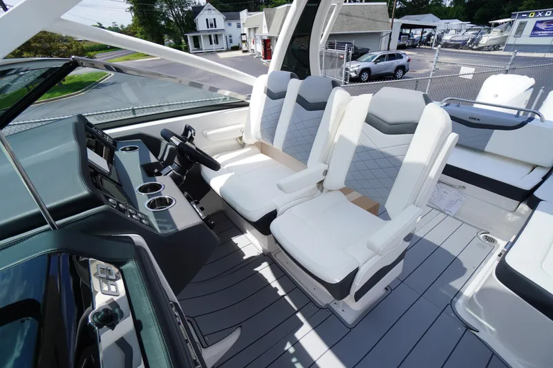 Slide: The Image of 2025 Chaparral 280 OSX boat interior with modern seating and sleek dashboard design. - 22