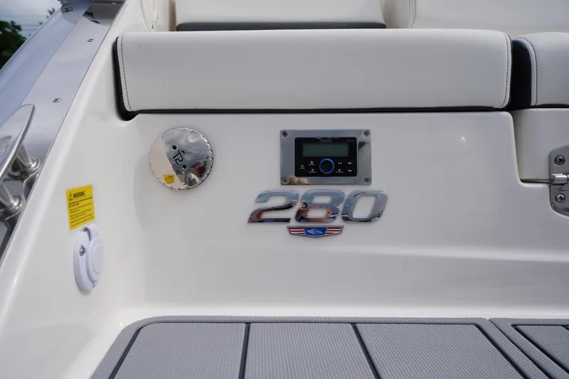 Slide: The Image of 2025 Chaparral 280 OSX boat interior with control panel and logo detail. - 4