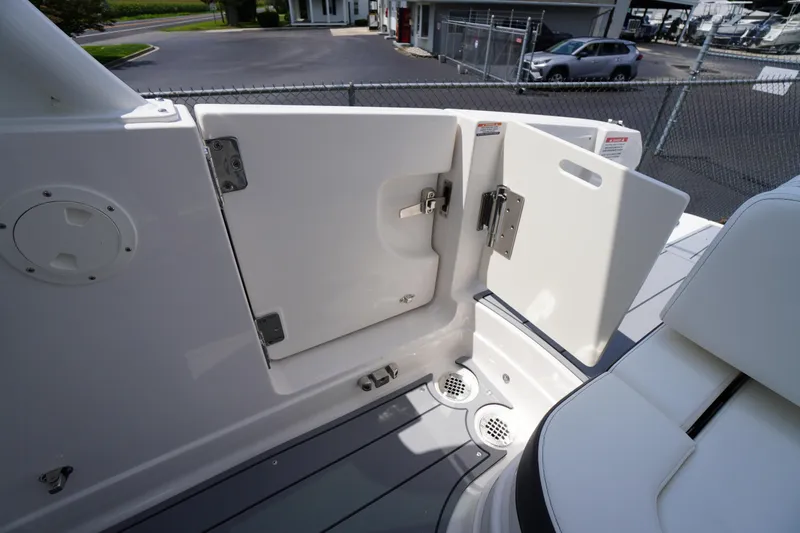 Slide: The Image of 2025 Chaparral 280 OSX boat interior with open hatch and seating area. - 40