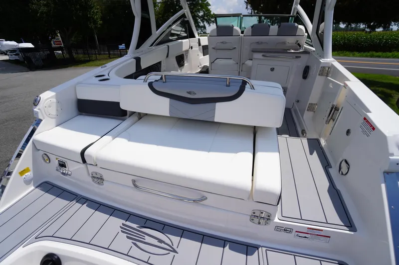 Slide: The Image of 2025 Chaparral 280 OSX boat interior with sleek white seating and modern design. - 42