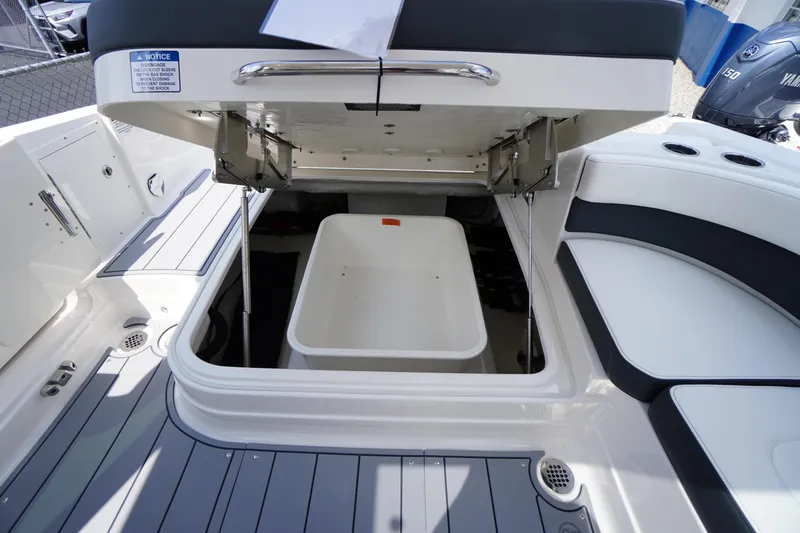 Slide: The Image of 2025 Chaparral 280 OSX boat storage compartment open, showcasing spacious interior design. - 44