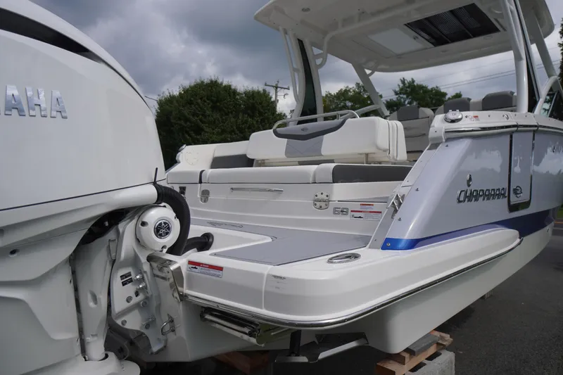 Slide: The Image of 2025 Chaparral 280 OSX boat with Yamaha engine, rear view, sleek design, outdoor setting. - 6