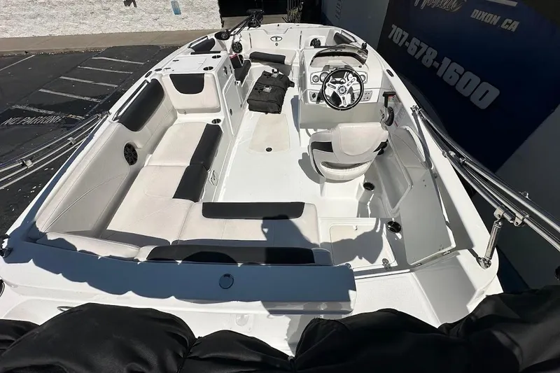 Slide: The Image of 2019 Tahoe 2150 boat interior with seating, steering wheel, and controls. - 10