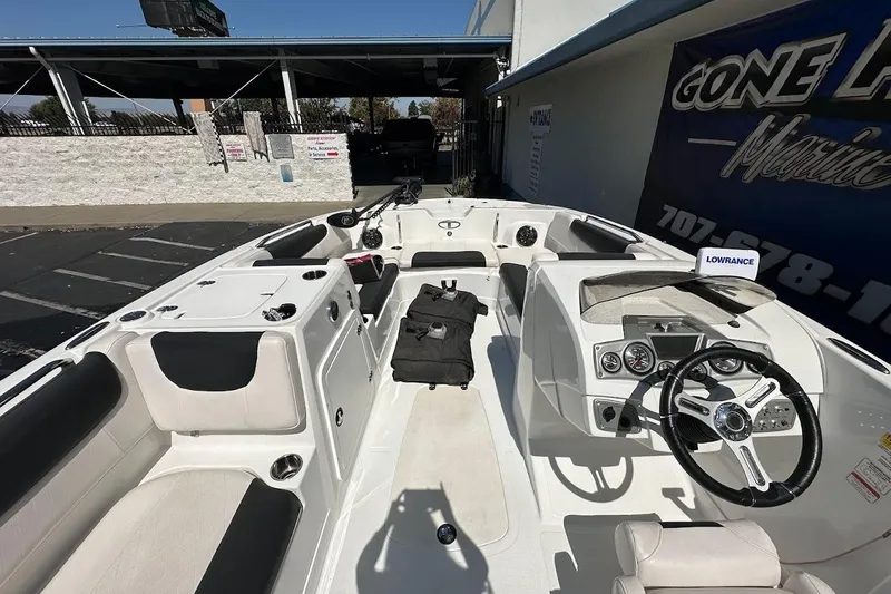 Slide: The Image of 2019 Tahoe 2150 boat interior with steering wheel, seating, and navigation equipment. - 17