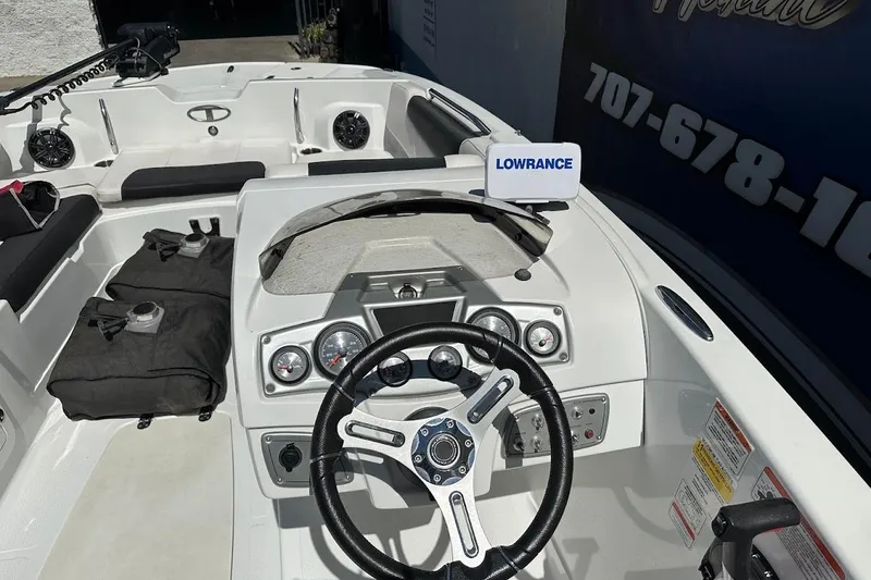 Slide: The Image of 2019 Tahoe 2150 boat interior with steering wheel and Lowrance navigation system. - 19