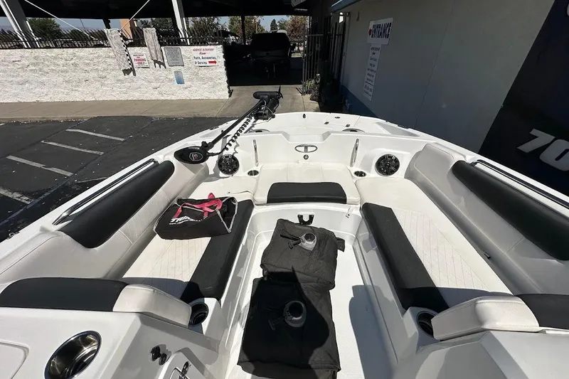 Slide: The Image of 2019 Tahoe 2150 boat interior with seating, cup holders, and accessories. - 21