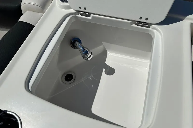 Slide: The Image of 2019 Tahoe 2150 boat sink with faucet and open lid. - 27