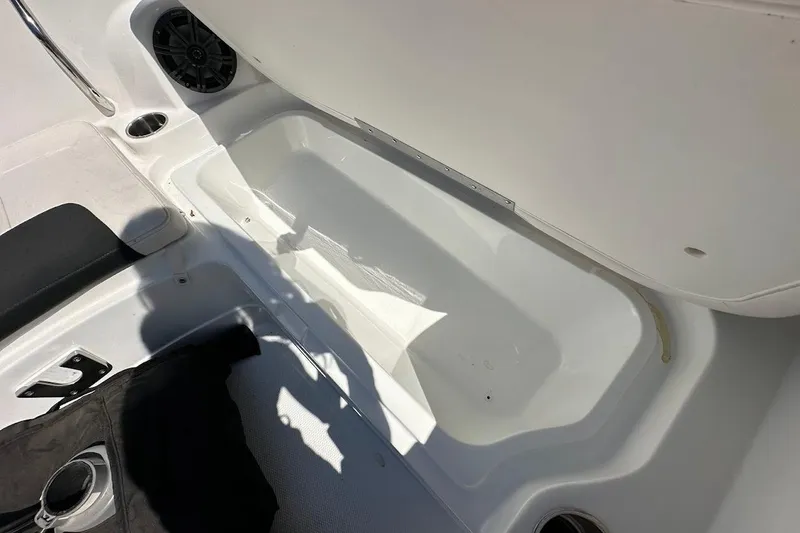 Slide: The Image of Interior of a 2019 Tahoe 2150 boat showing storage compartment and seating area. - 28