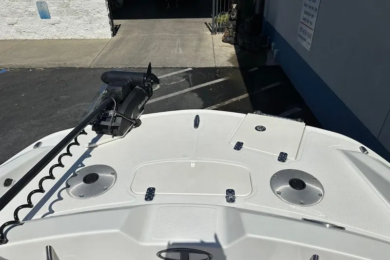 Slide: The Image of 2019 Tahoe 2150 boat deck with trolling motor and storage compartments. - 30