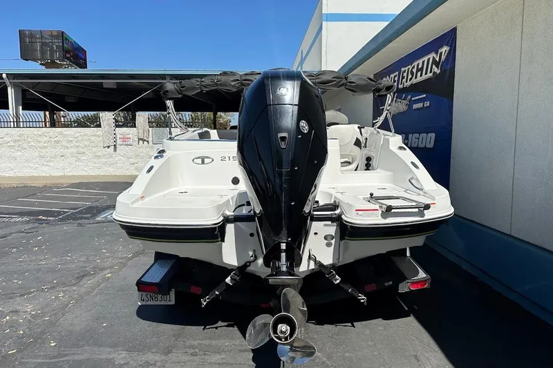 Slide: The Image of 2019 Tahoe 2150 boat with outboard motor in parking lot. - 8