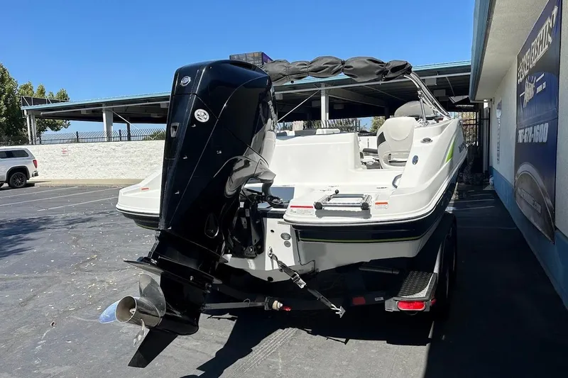 Slide: The Image of 2019 Tahoe 2150 boat with outboard motor in a parking lot. - 9