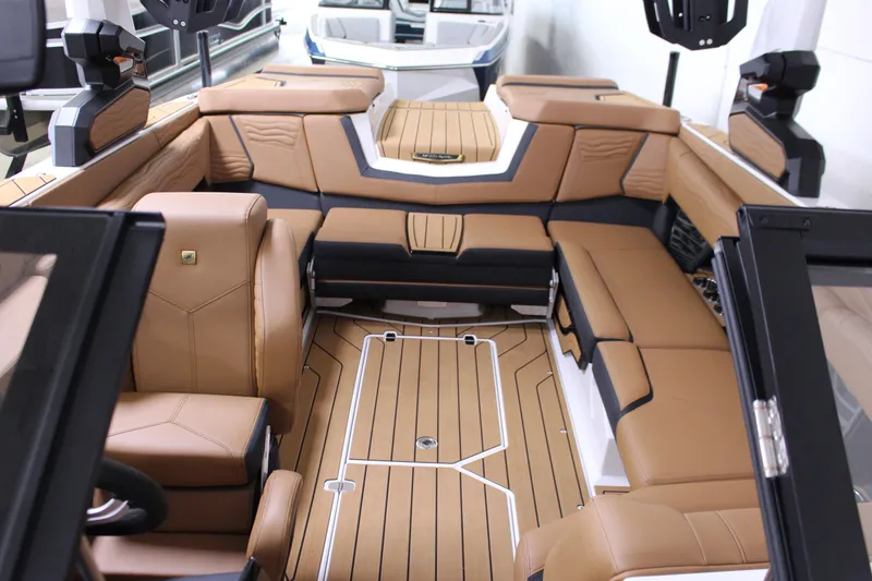 Slide: The Image of 2025 Nautique Super Air G23 interior with luxurious tan seating and sleek design. - 11