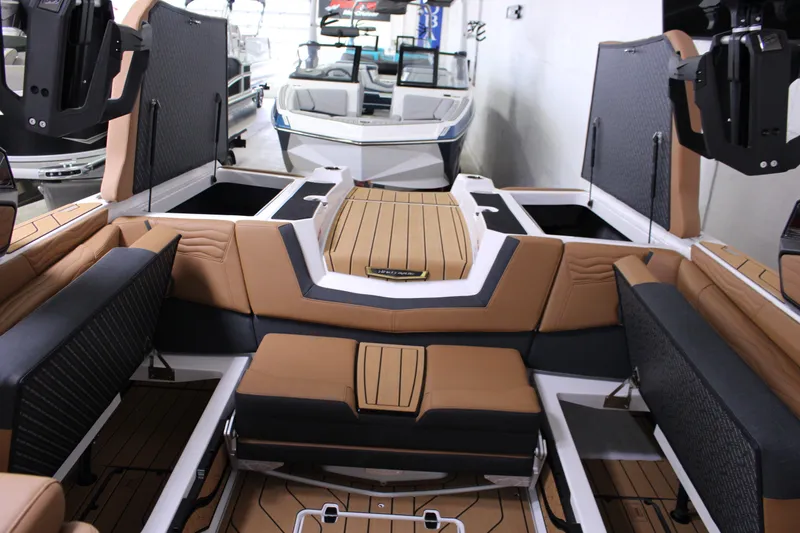 Slide: The Image of 2025 Nautique Super Air G23 interior with luxurious seating and storage compartments. - 12