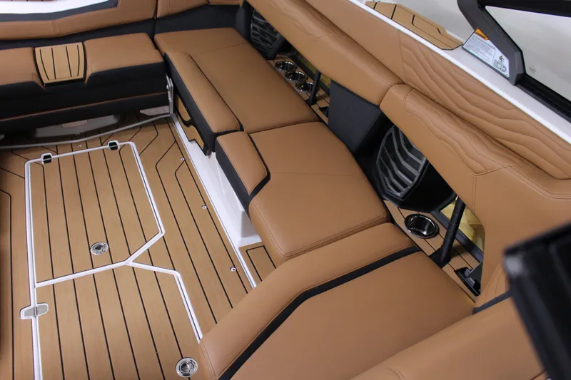 Slide: The Image of Luxurious interior of 2025 Nautique Super Air G23 with tan seating and teak flooring. - 14