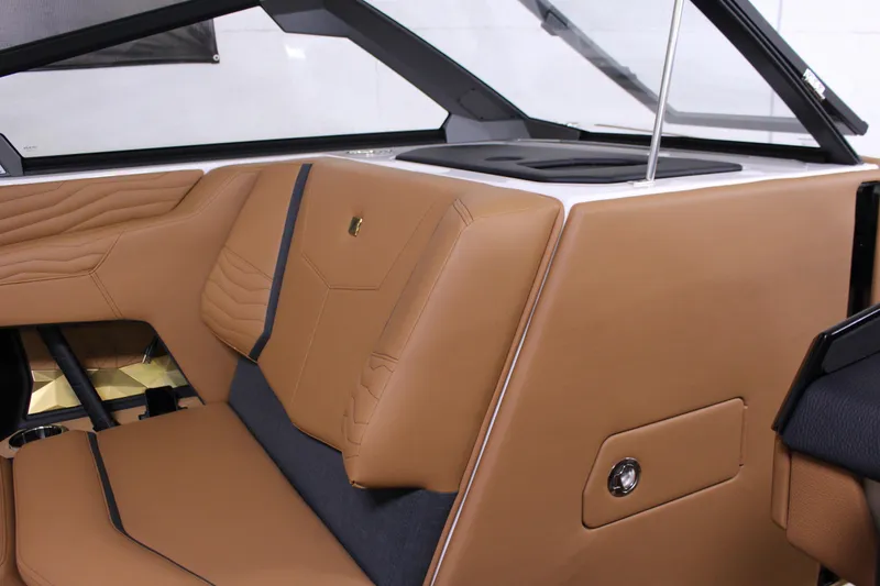 Slide: The Image of 2025 Nautique Super Air G23 interior with luxurious tan and black seating. - 15