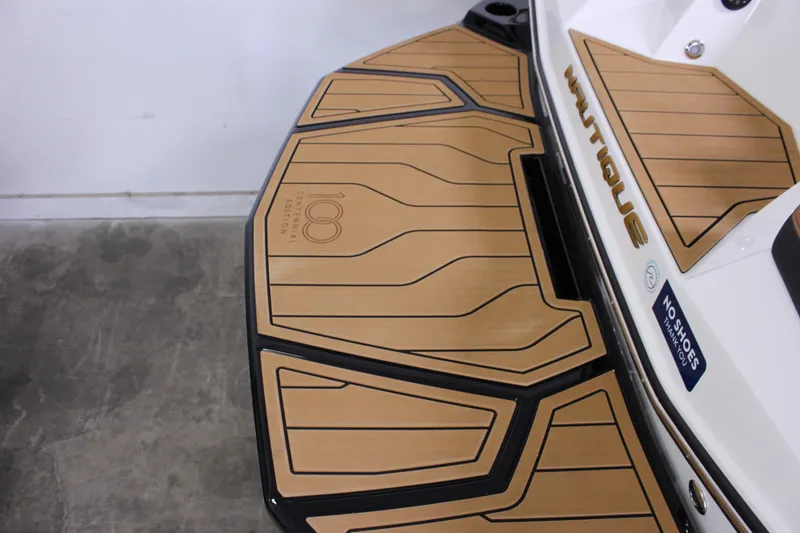 Slide: The Image of 2025 Nautique Super Air G23 boat deck with custom teak design and branding. - 17