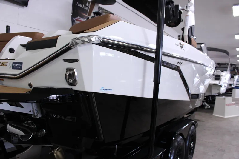 Slide: The Image of 2025 Nautique Super Air G23 boat displayed indoors on a trailer. - 4