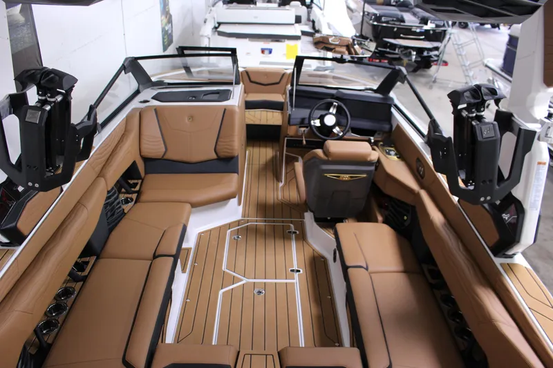 Slide: The Image of 2025 Nautique Super Air G23 interior with luxurious brown seating and modern dashboard design. - 5