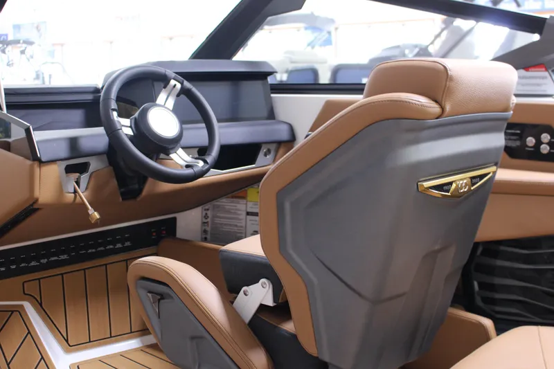 Slide: The Image of 2025 Nautique Super Air G23 boat interior with modern steering and luxurious seating. - 6