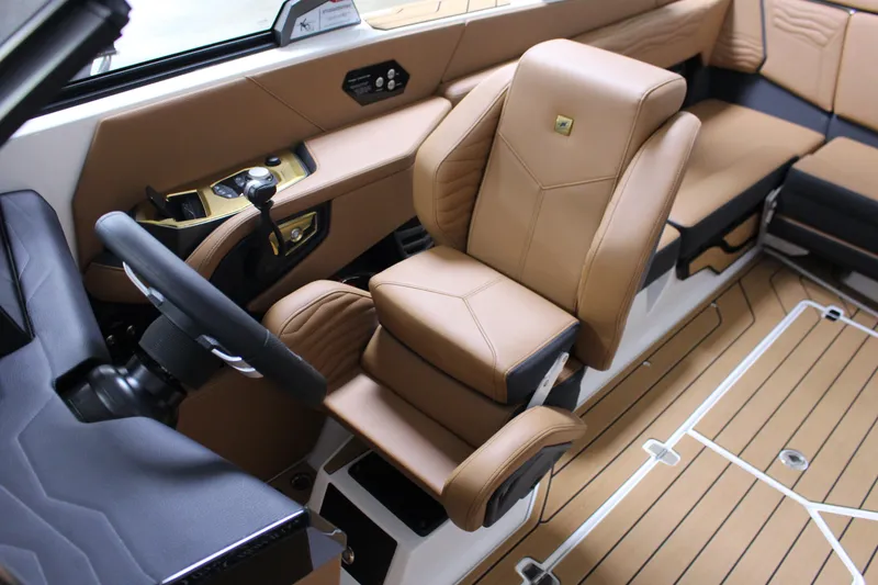 Slide: The Image of 2025 Nautique Super Air G23 interior with luxurious tan seating and modern controls. - 7