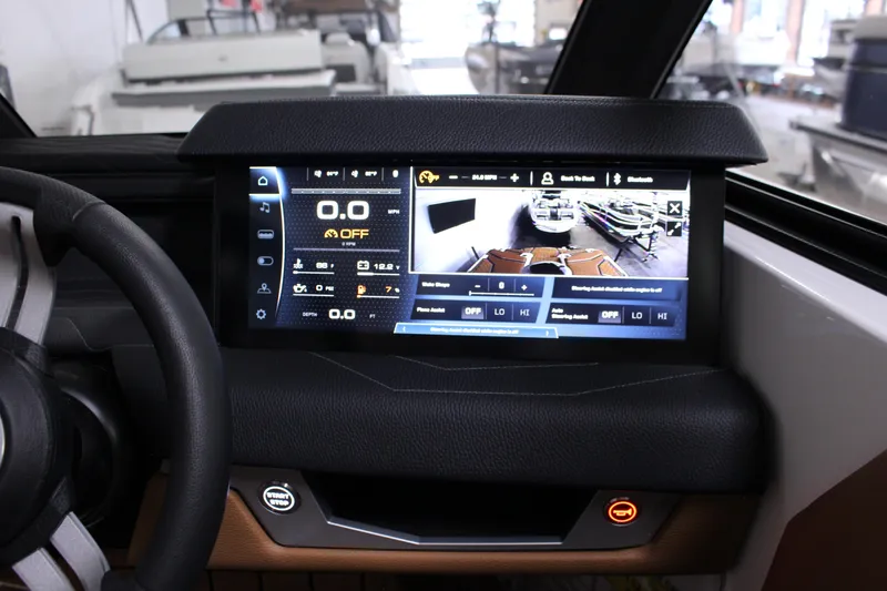 Slide: The Image of 2025 Nautique Super Air G23 dashboard with advanced touchscreen display and steering wheel. - 8
