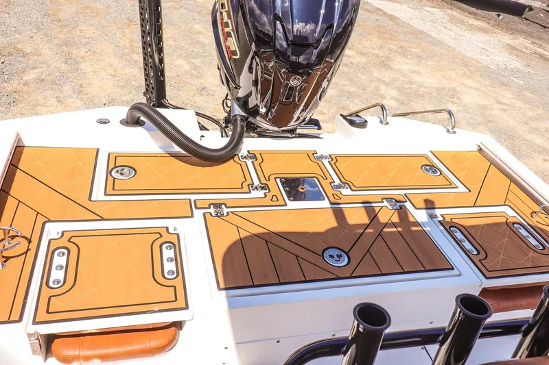 Slide: The Image of 2026 Avid 23 Fusion boat deck with storage compartments and outboard motor. - 11