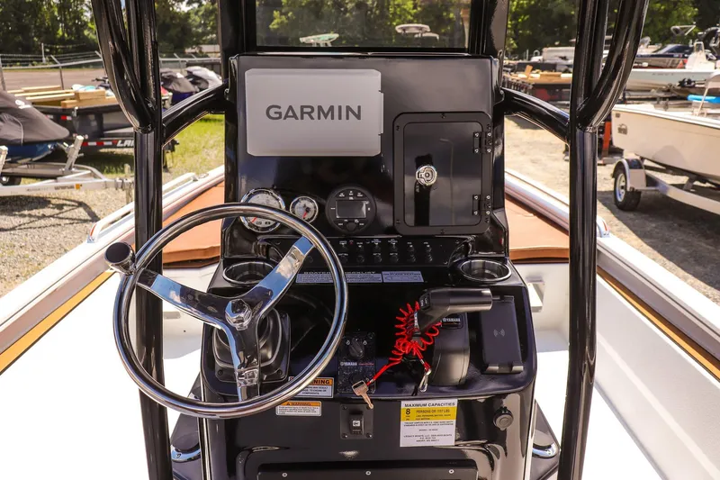 Slide: The Image of Avid 23 Fusion 2026 boat dashboard with Garmin navigation system and steering wheel. - 12