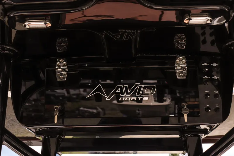Slide: The Image of Control panel of 2026 Avid 23 Fusion boat with logo and keys. - 13