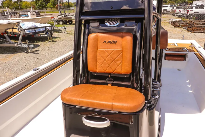 Slide: The Image of Avid 23 Fusion 2026 boat with tan leather seating and sleek black console. - 18