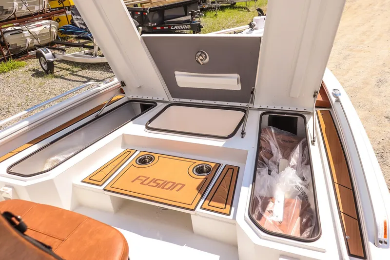 Slide: The Image of 2026 Avid 23 Fusion boat interior with storage compartments and seating area. - 22