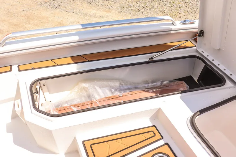 Slide: The Image of Open storage compartment on 2026 Avid 23 Fusion boat, featuring sleek design and ample space. - 24