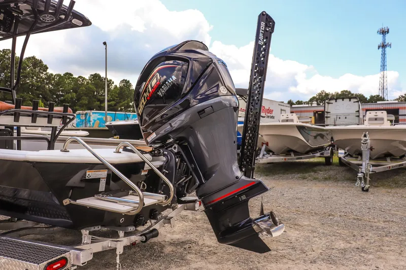 Slide: The Image of Avid 23 Fusion 2026 boat with powerful outboard motor in a marina setting. - 29