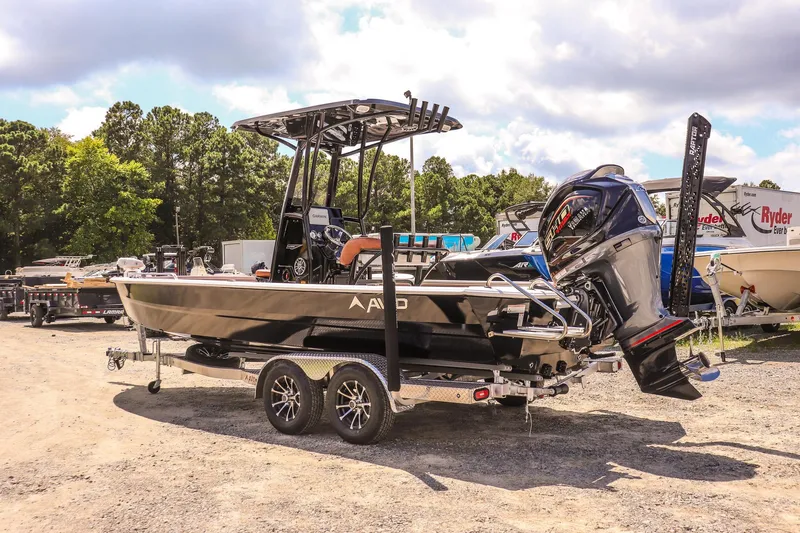 Slide: The Image of 2026 Avid 23 Fusion boat on trailer, parked outdoors under a cloudy sky. - 3