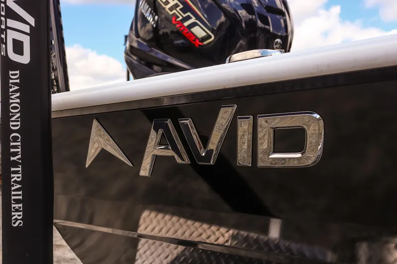 Slide: The Image of Close-up of 2026 Avid 23 Fusion boat with logo and trailer branding. - 32