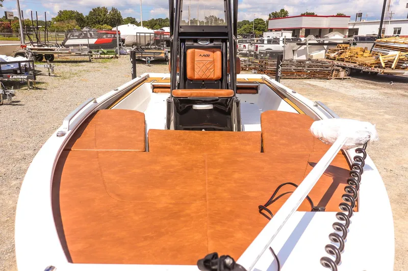 Slide: The Image of 2026 Avid 23 Fusion boat with brown deck, parked outdoors. - 9