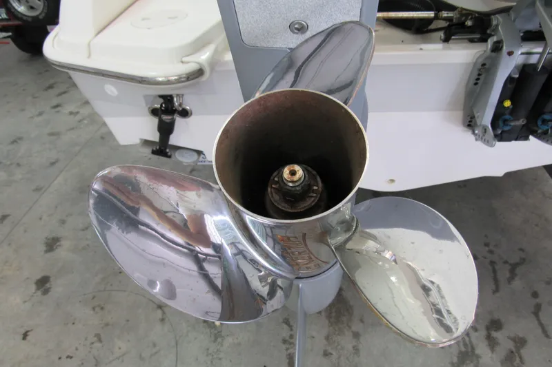 Slide: The Image of 2019 Boston Whaler 270 Dauntless boat propeller, close-up view in a garage setting. - 10
