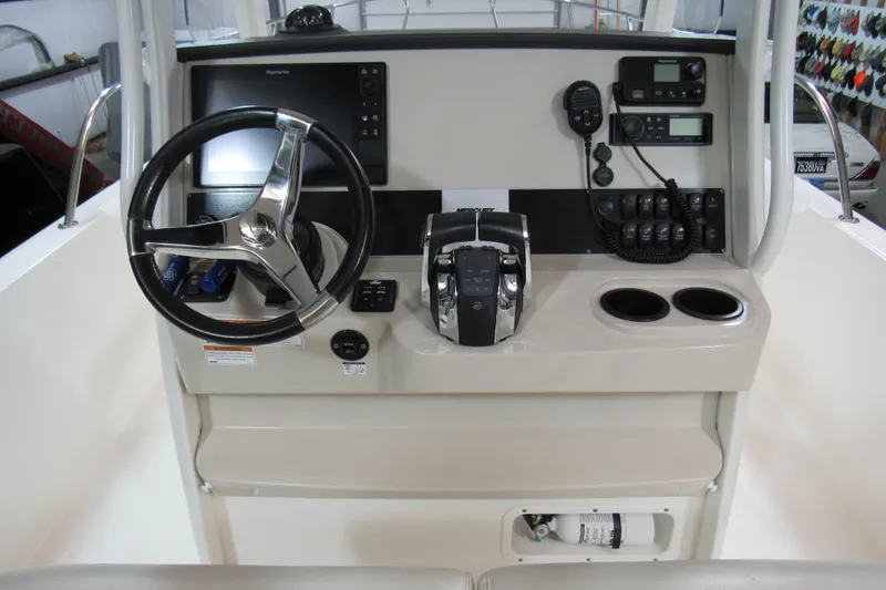 Slide: The Image of 2019 Boston Whaler 270 Dauntless helm with steering wheel, controls, and electronics. - 11