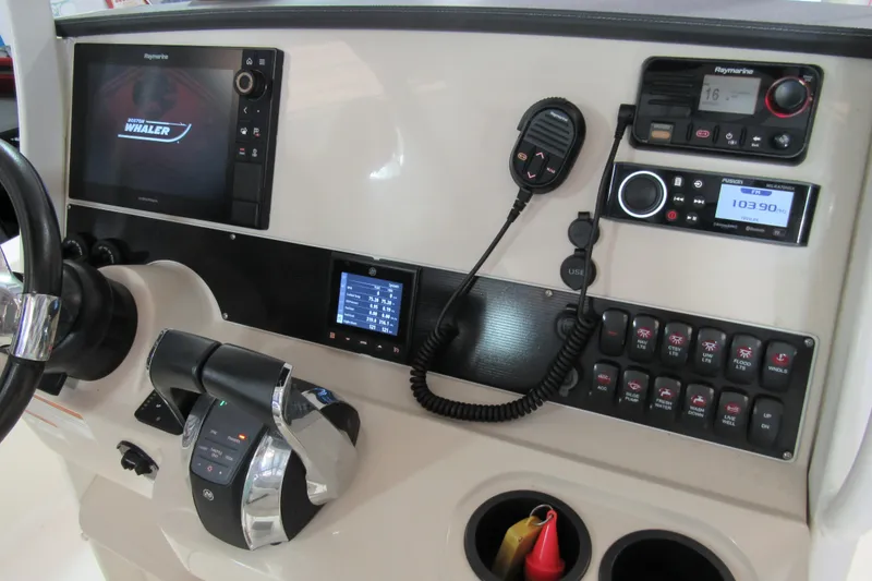 Slide: The Image of 2019 Boston Whaler 270 Dauntless dashboard with navigation and communication controls. - 12