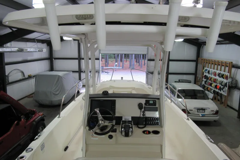 Slide: The Image of 2019 Boston Whaler 270 Dauntless boat in garage, showcasing helm and interior features. - 16