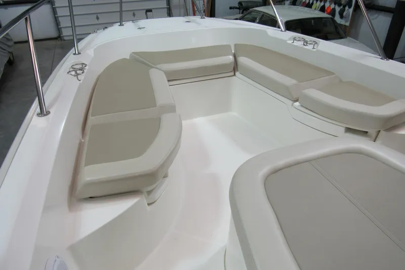Slide: The Image of 2019 Boston Whaler 270 Dauntless boat interior with cushioned seating and stainless steel railings. - 19