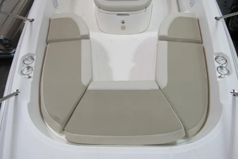 Slide: The Image of 2019 Boston Whaler 270 Dauntless boat interior with cushioned seating and cup holders. - 20