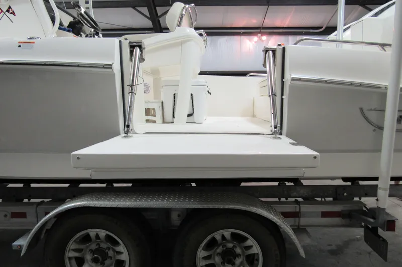 Slide: The Image of 2019 Boston Whaler 270 Dauntless boat on trailer, rear view in indoor storage. - 5